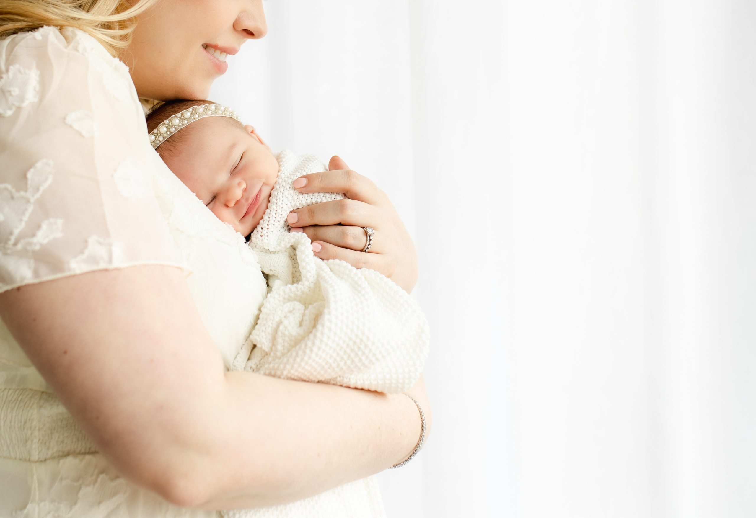 smiling newborn snuggling on mom's chest by Northern Virginia Newborn Photographer