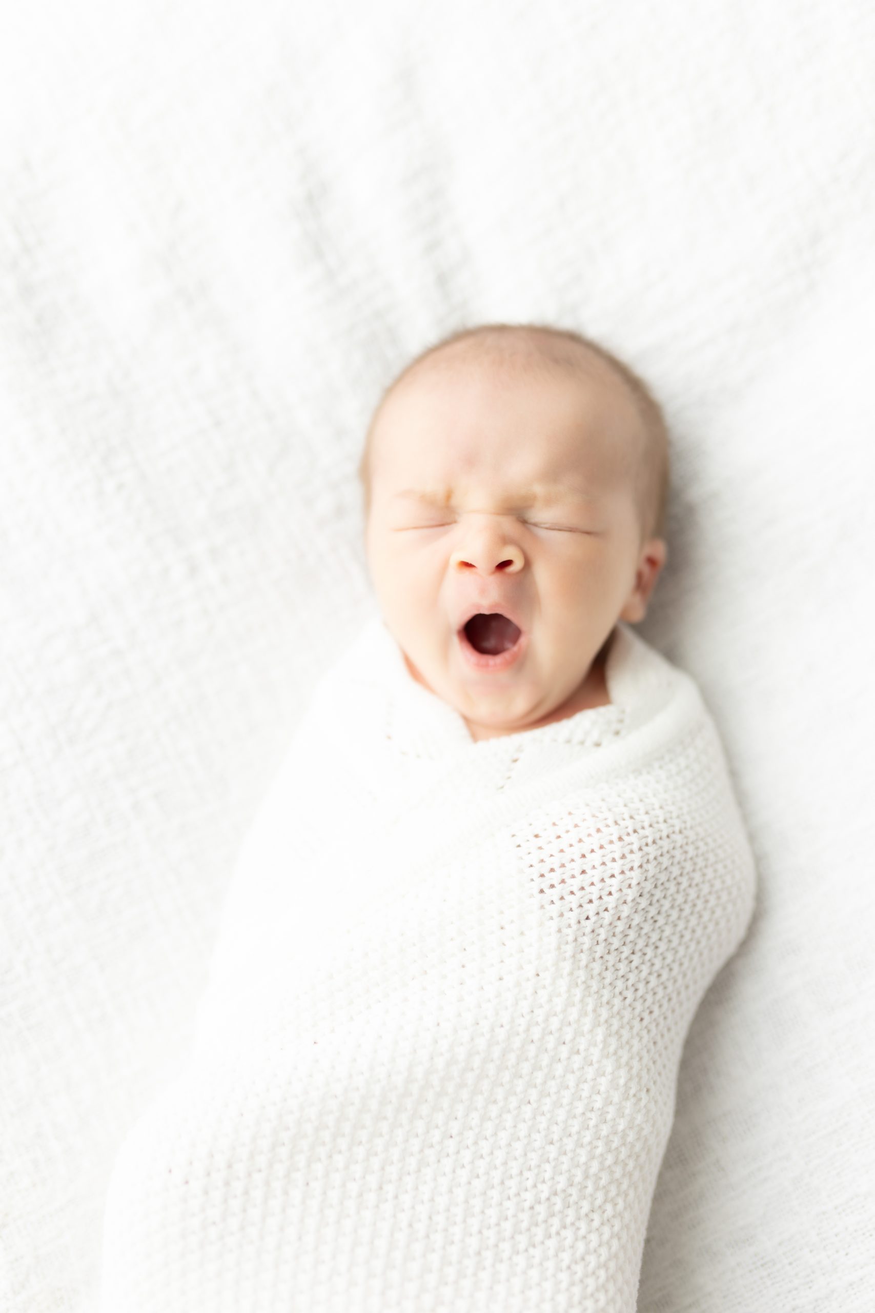 yawning newborn baby by DC Newborn Photographer