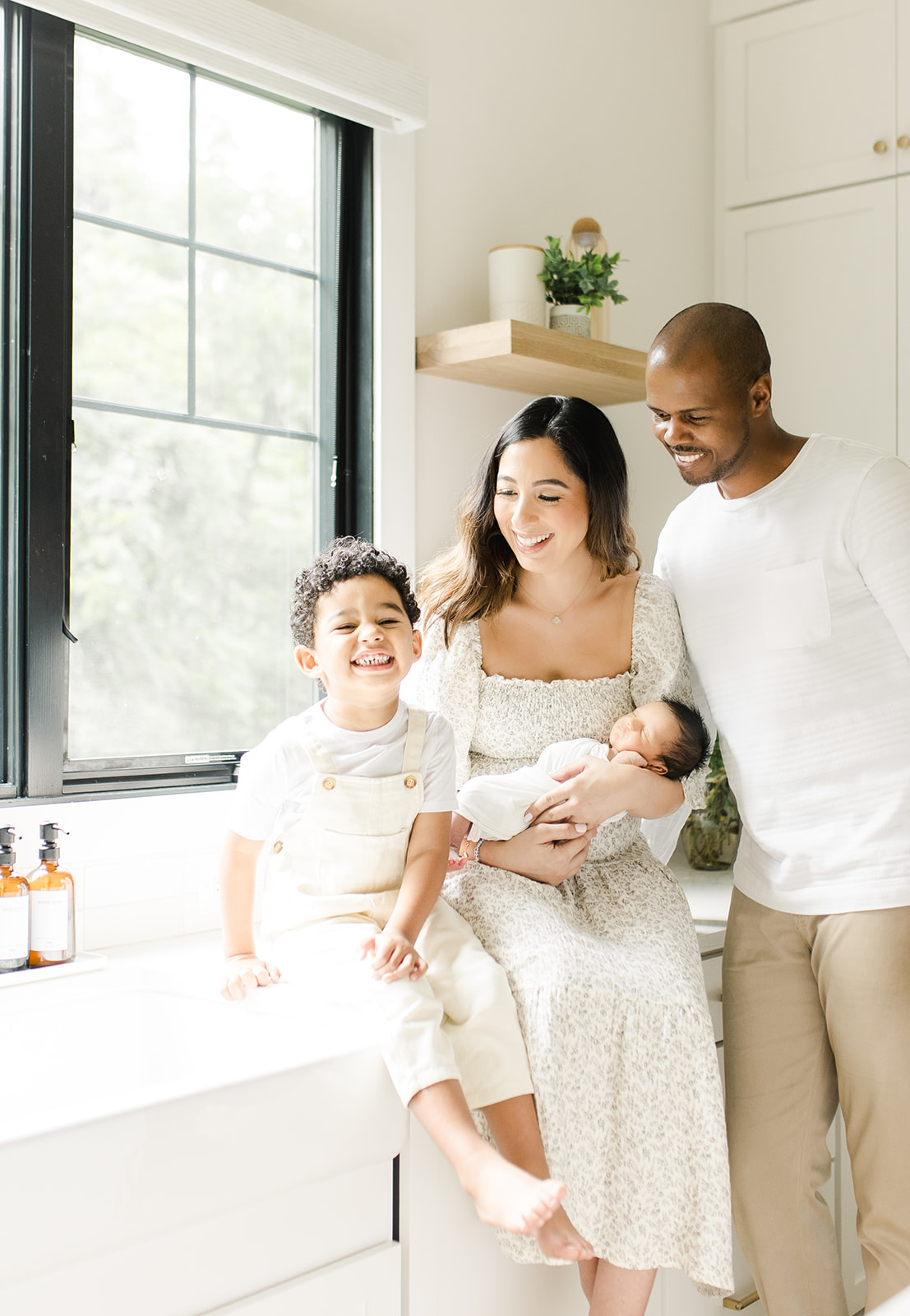 family hanging out in their kitchen at a newborn session