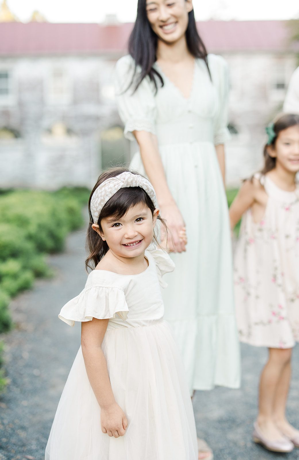 little girl smiling at the camera during family session at the state arboretum of va