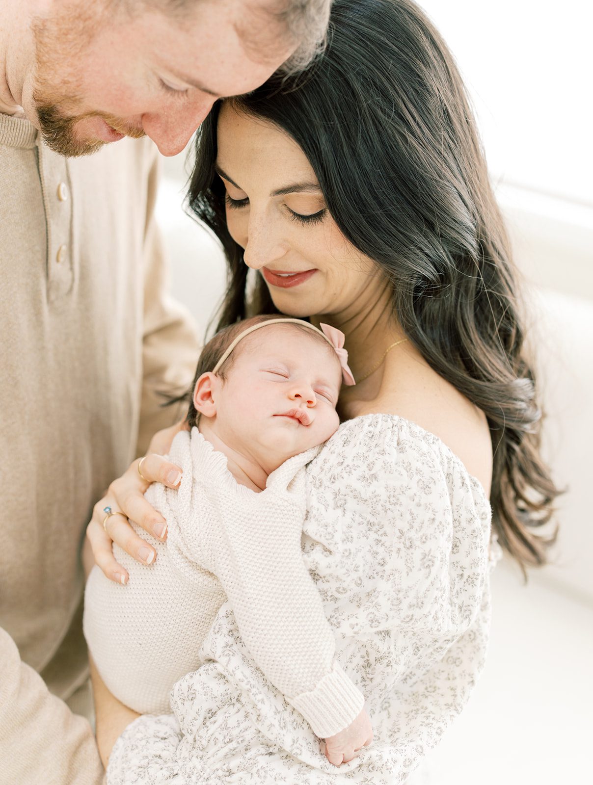 Mom and Dad snuggling baby girl by DC Newborn photographer