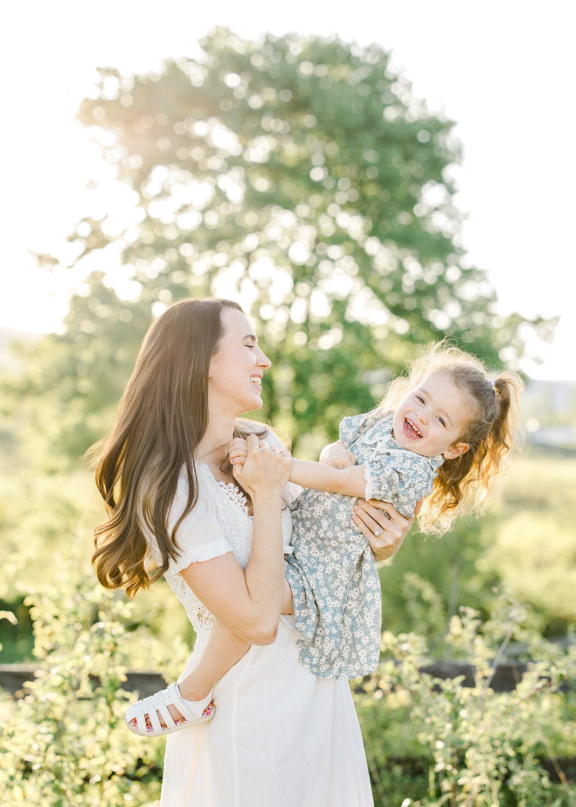 smiling toddler with her mom